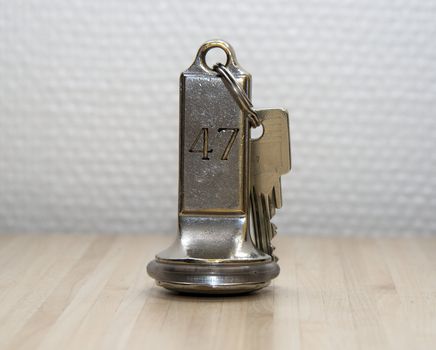 hotel key number forty seven on wooden table