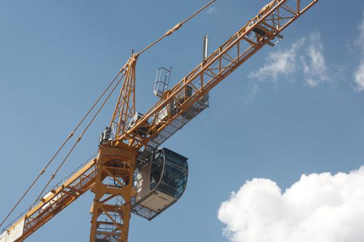 The elevating crane on construction of a building