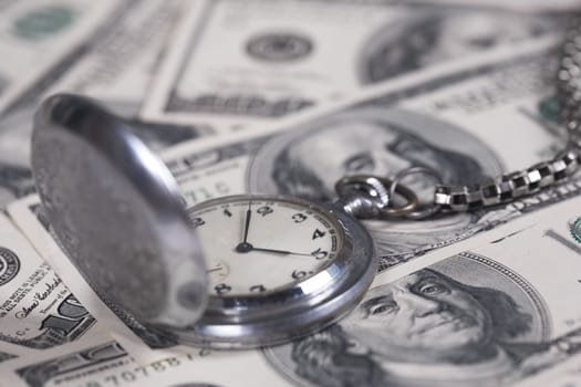 Silver clock with a watch-chain and dollars