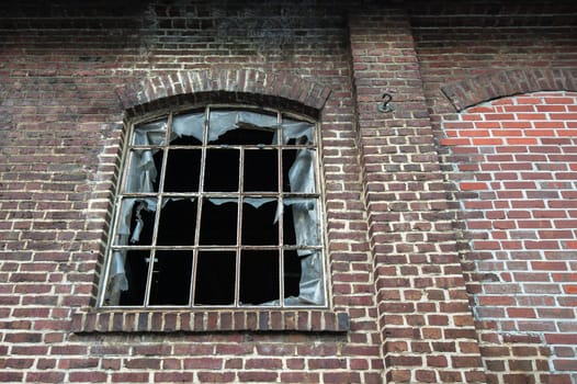 A broken window in old worn down building
