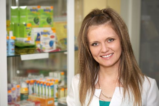 Medicine. Chemist woman standing in pharmacy drugstore 