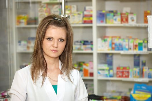 Medicine. Chemist woman standing in pharmacy drugstore. A female portrait
