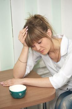 Tiredness. The woman the doctor drinks coffee in hospital