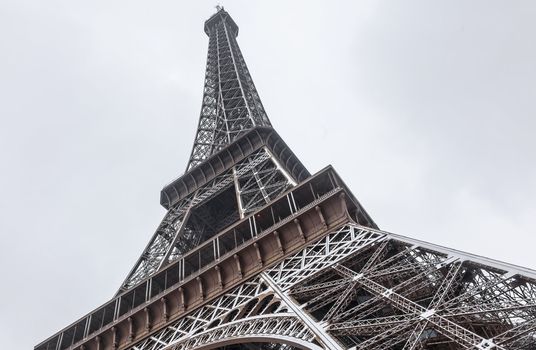 Detail of the Eiffel Tower covered by snow during the winter.