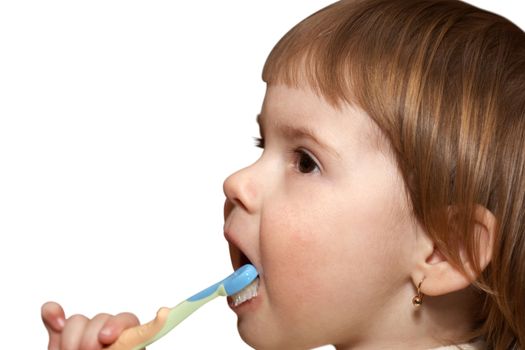 Hygiene. The small girl cleans teeth in a room