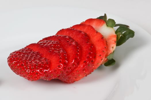 Sliced strawberry on white plate