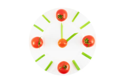 Plate with tomatoes and green onions in a natural clock