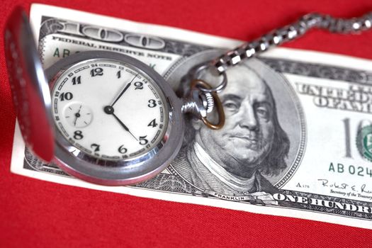 The dollars and clock lay on a table