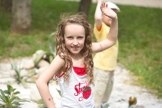 The girl on a nature waves a hand