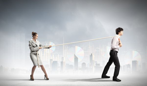 Image of three businesspeople with rope against diagram background
