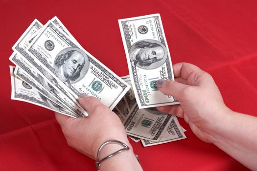 Dollars and hands on a red background