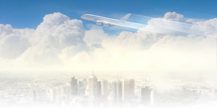 Image of flying airplane above city with clouds at background