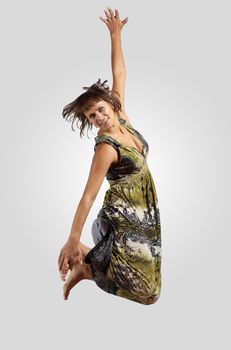 pretty modern slim hip-hop style woman jumping dancing on a grey background