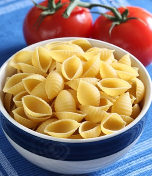Pasta inside bowl and tomato