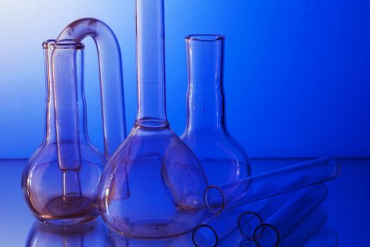 Laboratory glasswares for the analysis on a blue background