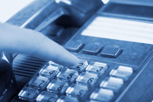 The dark blue telephone on a blue background