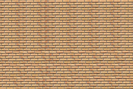 A background. Wall of a house from a yellow brick