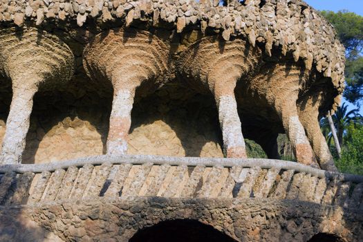Columns stone aqueduct of a building designed by Gaudi in park Guel in Barcelona