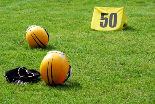 American football helmet and equipment on field