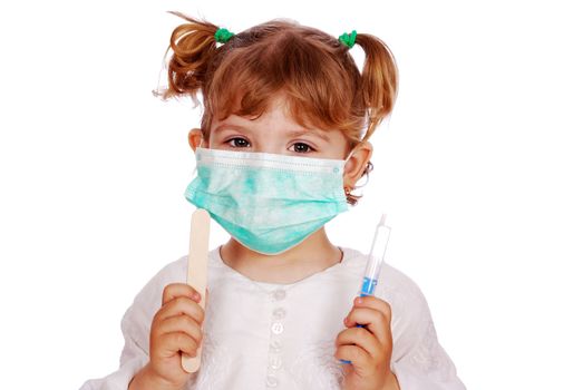 Little girl doctor in mask with syringe studio shot