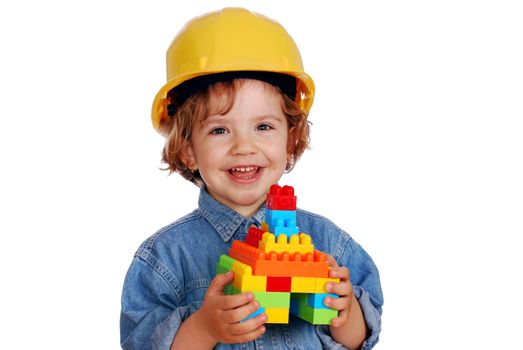 Little girl builder with toy block house studio shot