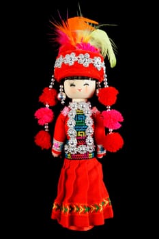 Chinese traditional style doll in red dress isolated on black