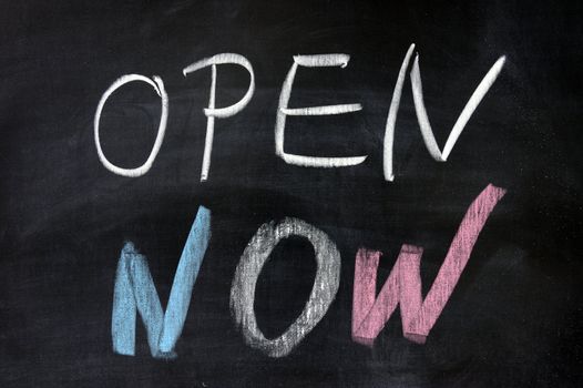 Chalk drawing - "open now" words written on chalkboard