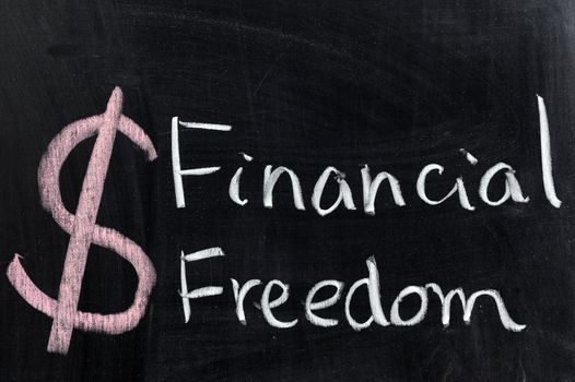 Chalk drawing - Financial freedom words written on chalkboard