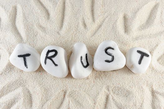 Trust word on group of stones on the sand