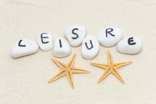 Leisure word on group of stones with sand background decorated with two sea stars