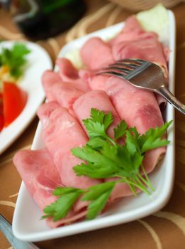 Beautiful sliced food arrangement with some vegetables. Shallow depth-of-field