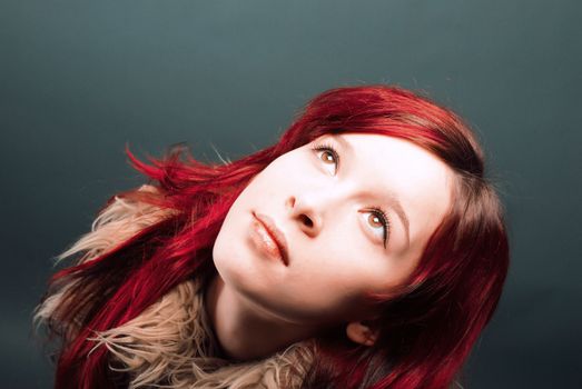 Emo look   girl with red hair on  gray background