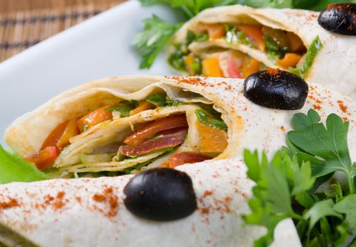 rolled pancakes stuffed with vegetables. Shallow depth-of-field.