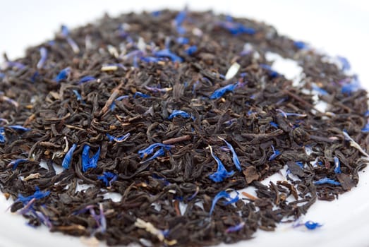 Earl Grey  teawith sheet cornflower and  bergamot,in studio shoton white background 