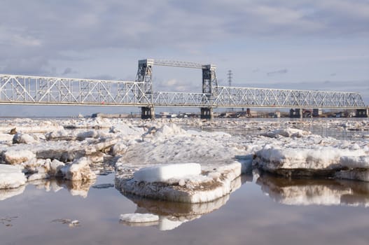 Railway bridge by springtime.Driving of ice goes On river