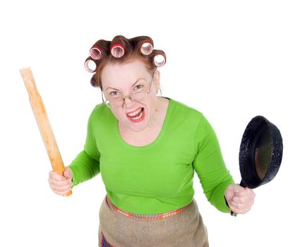 Angry crazy  housewife in hair rollers is holding.Angry look on face. Studio, white background. 