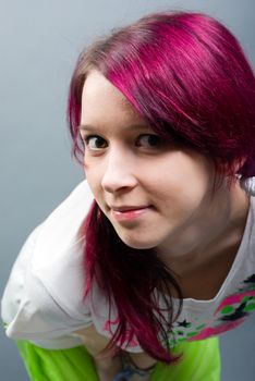 Emo look   girl with red hair on  gray background