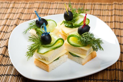 Canape with cheese and cucumber. closeup