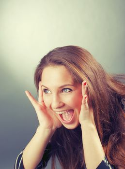 beautiful emotional brunette girl  on  gray background