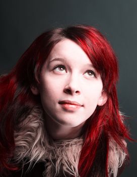    girl with red hair on  gray background