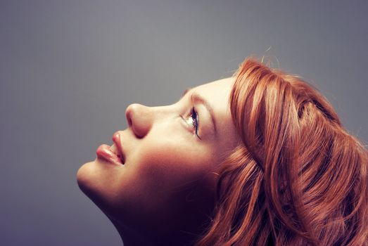 fashion portrait of a red hair sexy woman, studio shot 