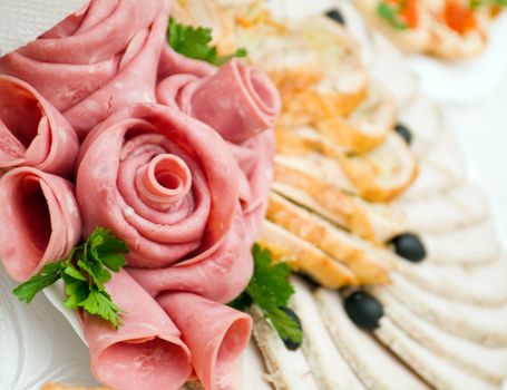 Beautiful sliced food arrangement with some vegetables. Shallow depth-of-field.  