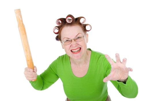 Angry crazy  housewife in hair rollers is holding.Angry look on face. Studio, white background. 