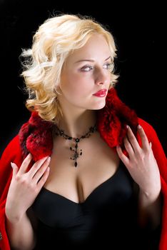 Sexy model wearing winter fur coat on  black  background 
