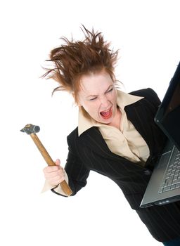 angry and stressed businesswoman smashing her laptop with a hammer 