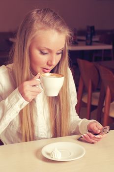 happy teenage girl   holding a cup of hot drink 