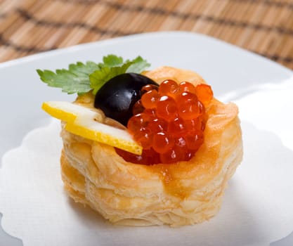   Canapes with red caviar  and lemon