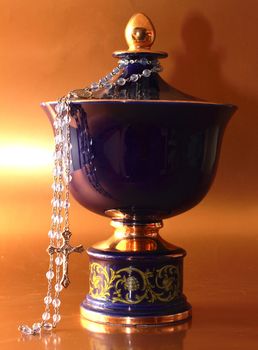 a picture a blu funeral urn with rosary