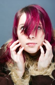 Emo look 
 girl with red hair on  gray background