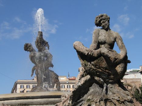 a fountain in the reppublic square on rome italy